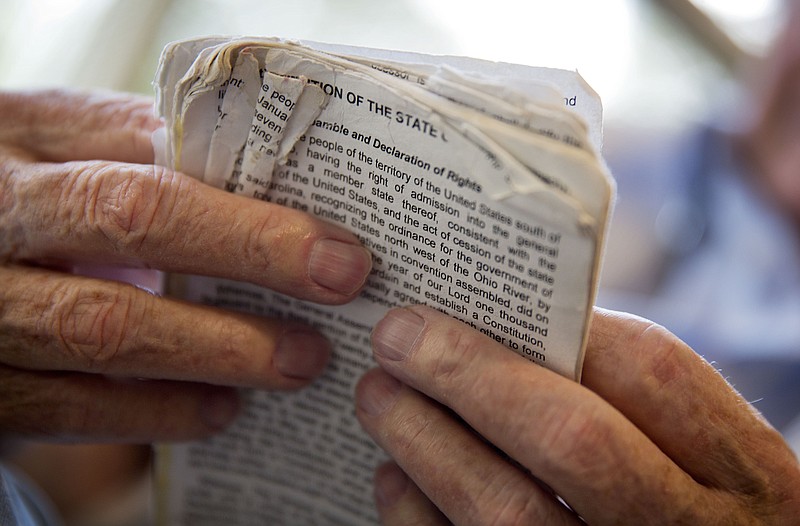 A man holds a copy of the Tennessee Constitution. (AP file photo/David Goldman)