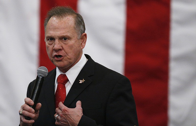 FILE- In this Dec. 11, 2017, file photo, U.S. Senate candidate Roy Moore speaks at a campaign rally in Midland City, Ala.  Moore on Thursday, Dec. 21, pleaded for donations to help him investigate potential election fraud, the same day Alabama officials said they investigated but found nothing improper regarding a TV interview that had raised suspicions. (AP Photo/Brynn Anderson, File)