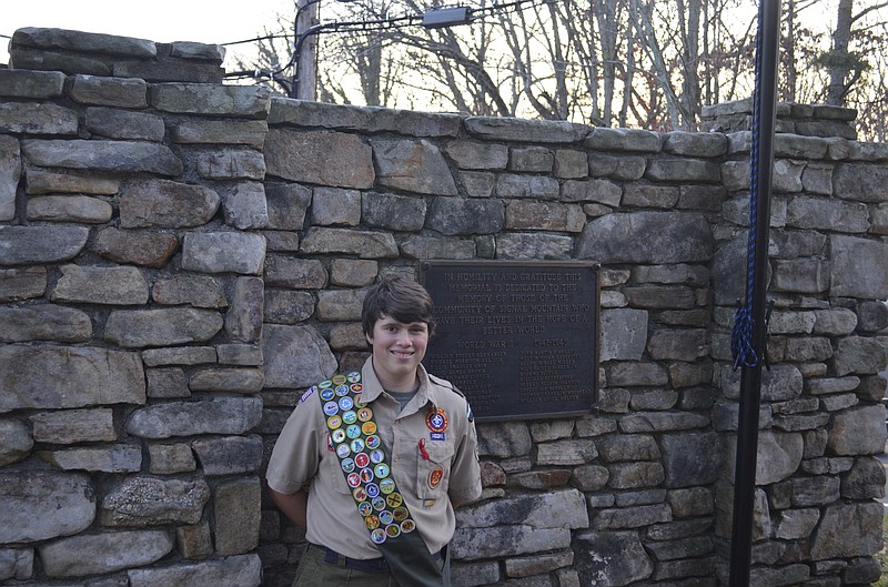 Turner Eades stands by the fountain at the World War II Memorial Park containing a plaque listing the names of the 21 men from Signal Mountain who were killed during the war. (Staff photo by Emily Crisman)