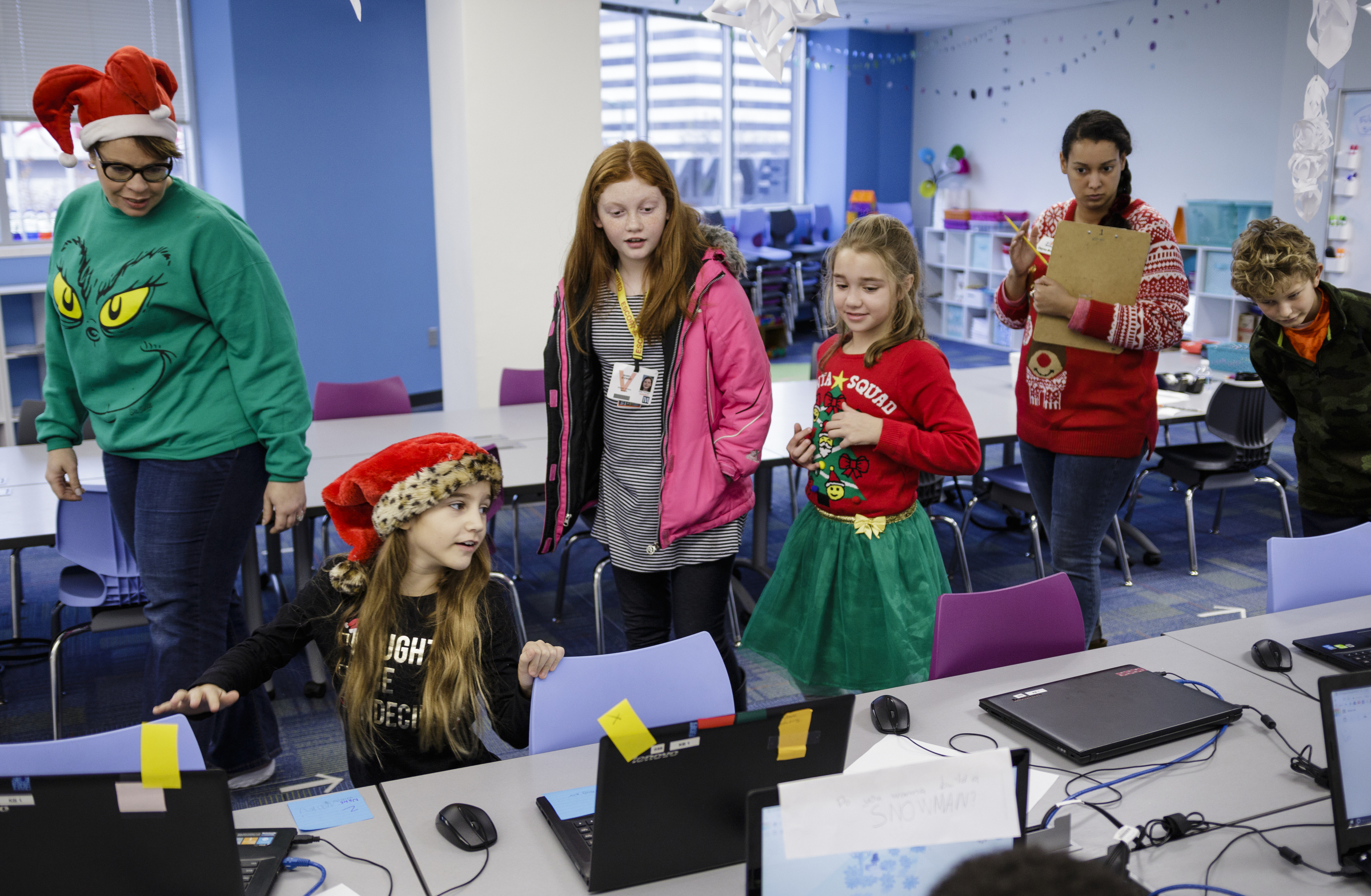 Students and teachers look at 3d snowmen created on laptops by their classmates at Tech Town's winter break camp in the Edney Innovation Center on Friday, Dec. 22, 2017, in Chattanooga, Tenn. Tech Town offers technology-centric camps and education for children in subjects ranging from video production and computer coding to electronics and robotics.