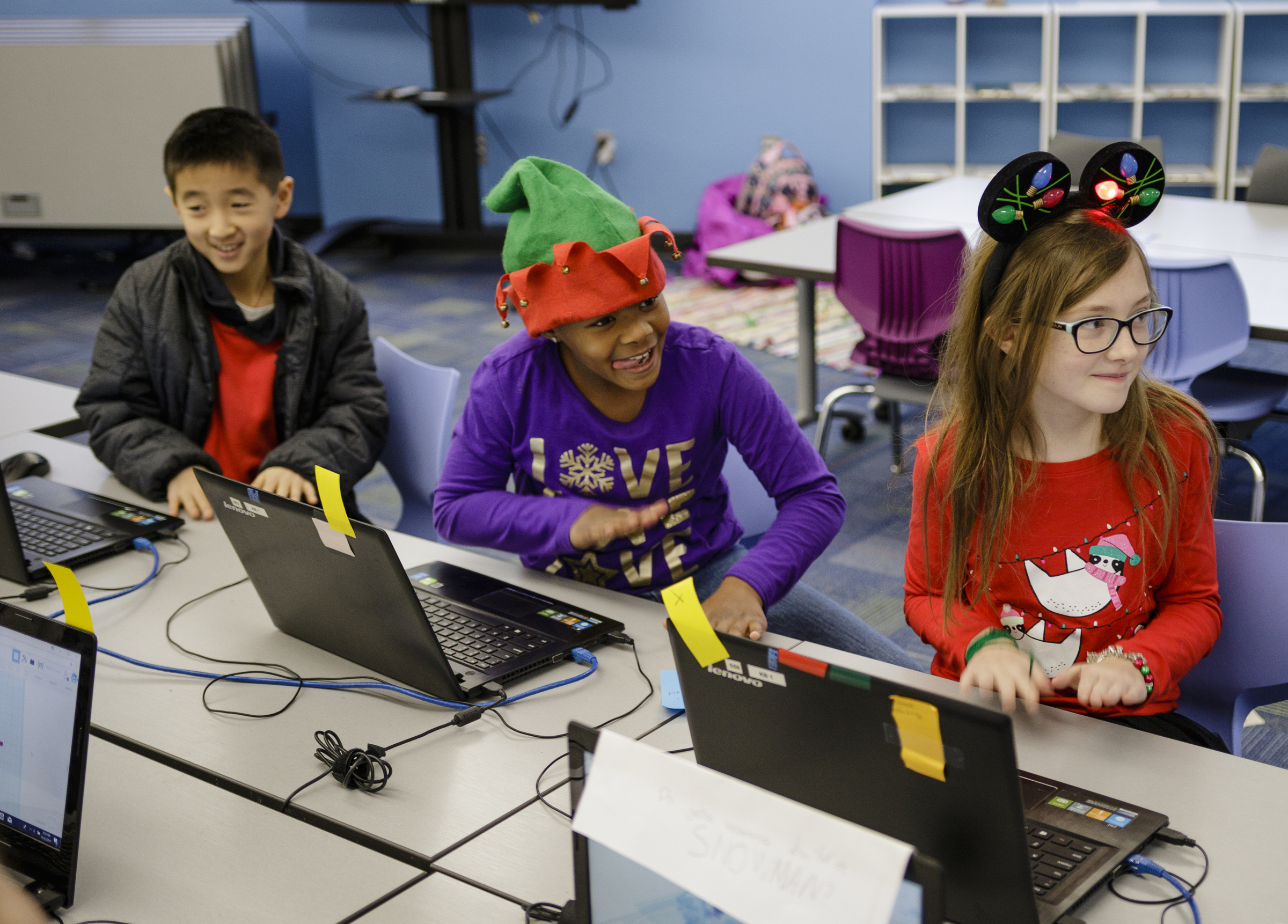William Yao, left, Naomi Williams, center, and Melody Miller give a drum-roll as their teacher announces prize winners at Tech Town's winter break camp in the Edney Innovation Center on Friday, Dec. 22, 2017, in Chattanooga, Tenn. Tech Town offers technology-centric camps and education for children in subjects ranging from video production and computer coding to electronics and robotics.