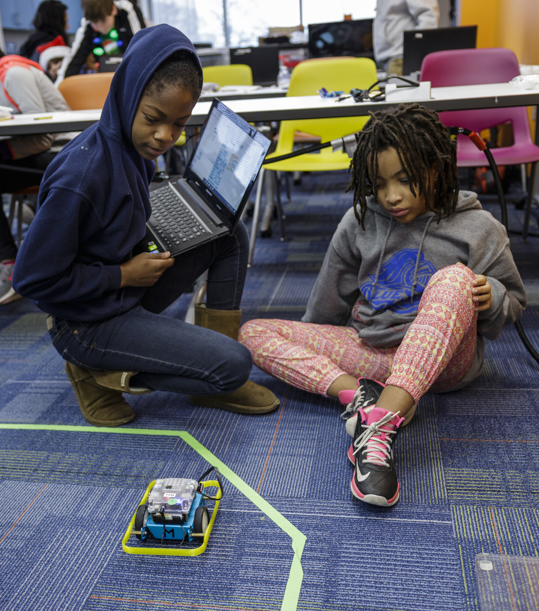 Ejanay Reynolds, left, and Mikayla Lake program a robot to move in a square in a robotics class at Tech Town's winter break camp in the Edney Innovation Center on Friday, Dec. 22, 2017, in Chattanooga, Tenn. Tech Town offers technology-centric camps and education for children in subjects ranging from video production and computer coding to electronics and robotics.