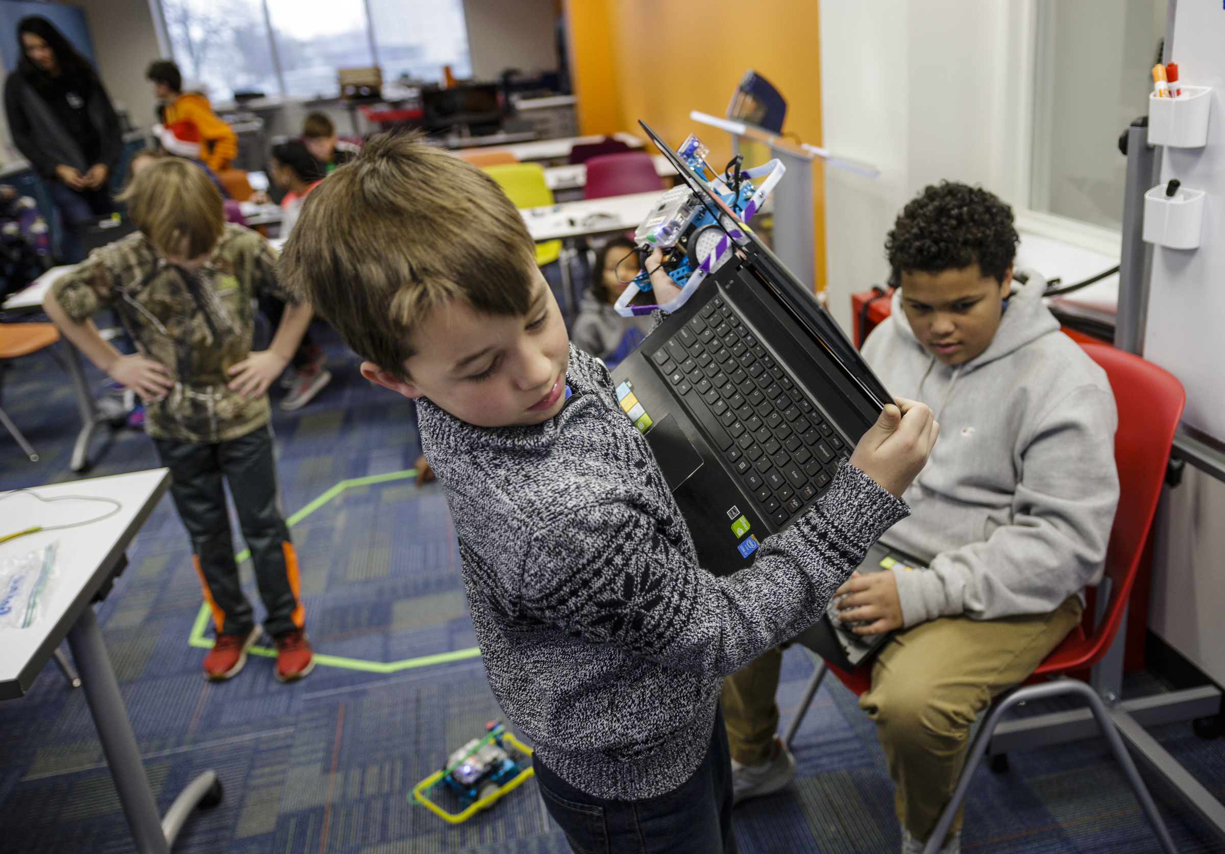 Ben Anz, left, Noah Stephens, center, and Markell Dardee work on programming robots in a robotics class at Tech Town's winter break camp in the Edney Innovation Center on Friday, Dec. 22, 2017, in Chattanooga, Tenn. Tech Town offers technology-centric camps and education for children in subjects ranging from video production and computer coding to electronics and robotics.