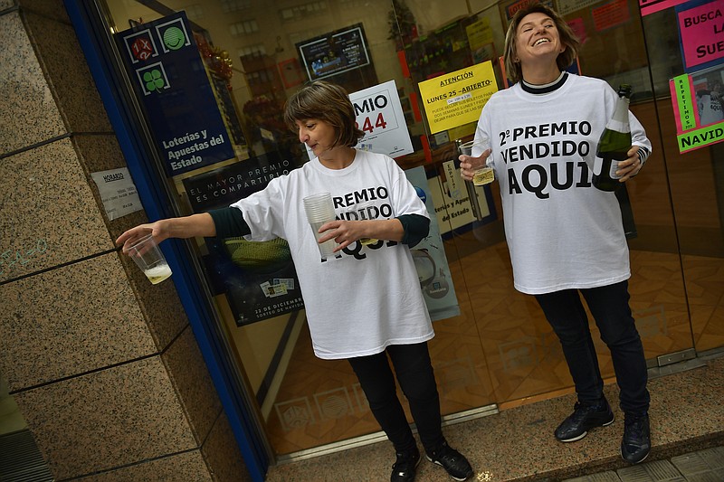 
              Eva Galdeano, right, owner of a lottery office, celebrates beside Carolina after selling the second prize Christmas lottery ticket ''El Gordo'' with the number 51244, in Pamplona, northern Spain, Friday, Dec. 22, 2017. (AP Photo/Alvaro Barrientos)
            