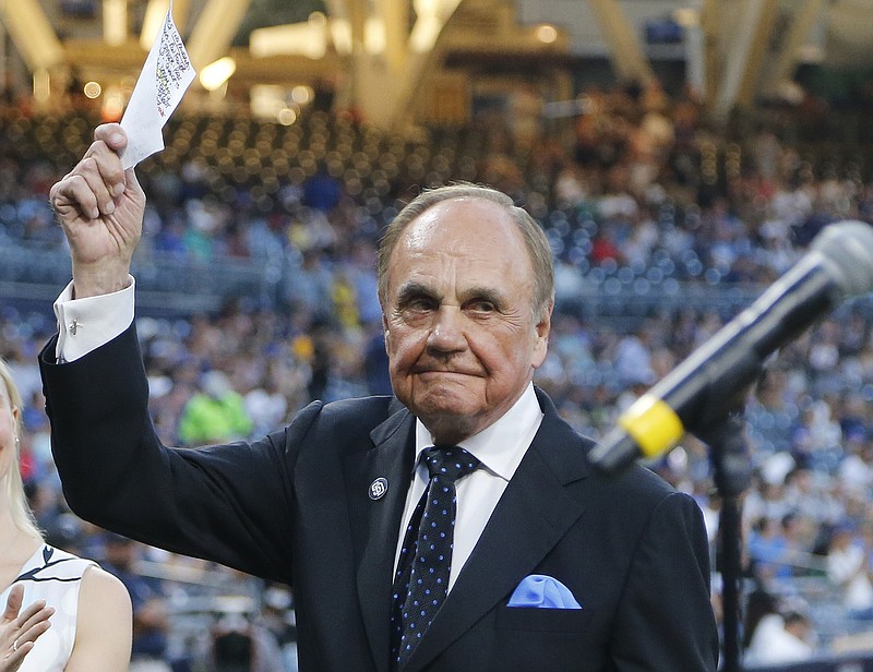 In this Sept. 29, 2016, file photo, San Diego Padres broadcaster Dick Enberg waves to crowd at a retirement ceremony prior to the Padres' final home baseball game of the season, against the Los Angeles Dodgers in San Diego. Enberg, the sportscaster who got his big break with UCLA basketball and went on to call Super Bowls, Olympics, Final Fours and Angels and Padres baseball games, died Thursday, Dec. 21, 2017. He was 82. Engberg's daughter, Nicole, confirmed the death to The Associated Press. She said the family became concerned when he didn't arrive on his flight to Boston on Thursday, and that he was found dead at his home in La Jolla, a San Diego neighborhood. (AP Photo/Lenny Ignelzi, File)