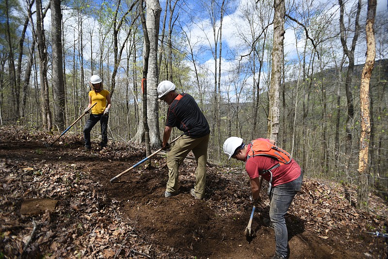 Sara Lewis, Marvin Webb, Charlotte Bossy, from left, with Rock Creek, work on the Pot Point Trail Friday, March 31, 2017.