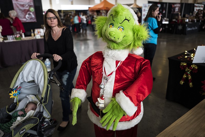 A mannequin dressed as the Grinch greets visitors at the Times Free Press's HoHo Expo at the Chattanooga Convention Center in 2016.