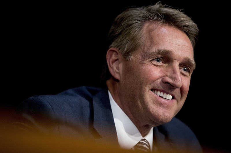 In this Oct. 31, 2017, file photo, Sen. Jeff Flake, R-Ariz., asks questions during a Senate Committee on Capitol Hill in Washington. Flake said President Donald Trump is certain to face an independent challenge in the next presidential election, if not a challenge from within the party. And Flake is not ruling out being that challenger. (AP Photo/Andrew Harnik, File)