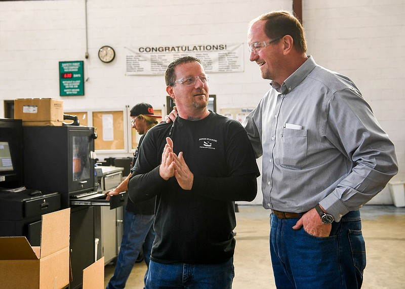 Engineering Plant Manager Eric Hicks, right, talks with Processor Tony Goode on Nov. 28 about the day's productivity at the Jones Plastic & Engineering Company in Camden, Tenn.