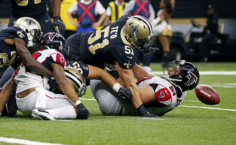 New Orleans Saints middle linebacker Manti Te'o (51) scrambles for a fumble by running back Devonta Freeman, left, over Atlanta Falcons center Alex Mack (51) in the second half of an NFL football game in New Orleans, Sunday, Dec. 24, 2017. (AP Photo/Butch Dill)