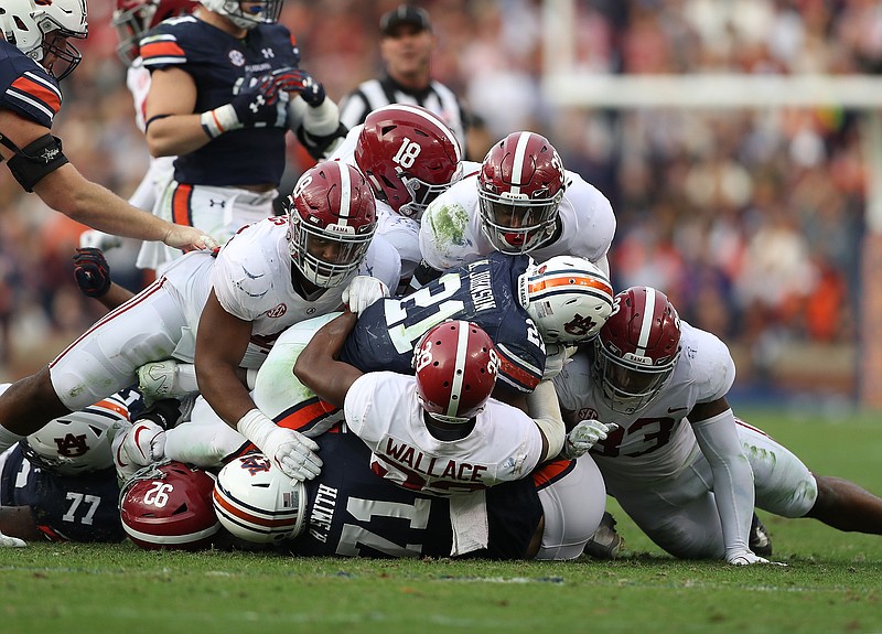 Alabama's defense, shown here bringing down Auburn's Kerryon Johnson in the Iron Bowl, struggled to get off the field on third downs in November league games against LSU, Mississippi State and Auburn.