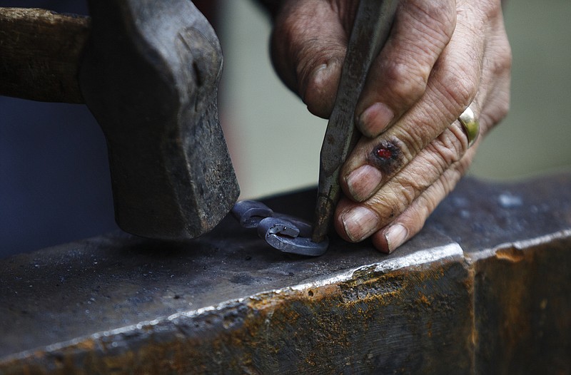 Blacksmith Ray Brown makes a miniature horse shoe at the Red Clay Pow Wow at Red Clay State Historic Park on Saturday, Oct. 28, 2017, in Cleveland, Tenn. 