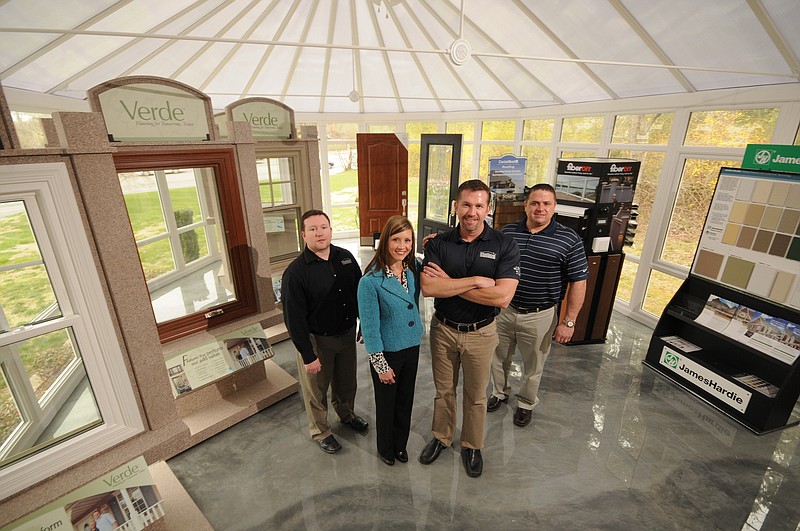 Staff photo by Tim Barber/Chattanooga Times Free Press - Apr 3, 2013 - The Hullco Exteriors executive staff stands in the showroom at the East Brainerd business. From left are Brian Brock, general manager, Jenny Hullander and Matt Hullander, owners, and Ray Edler, production manager.