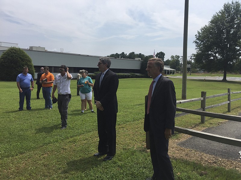 Gov. Bill Haslam, right, and Tennessee's economic commissioner Bob Wolfe talk at former Dura Automotive plant where Textile Corporation plans new 1,000-job plant.