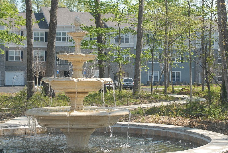 A walking path and fountain are situated between buildings at The Haven at Commons Park, a luxury apartment complex located near the shopping mall district in East Brainerd. 