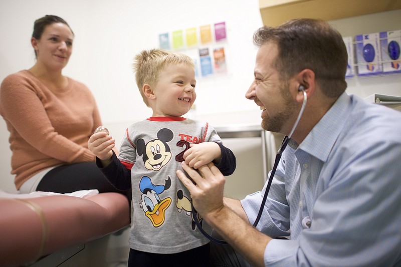Dr. Jonathan Miller checks Jay Dennis, 3, at a clinic in Delaware. The Children's Health Insurance Program, or CHIP, is a victim of the partisan rancor that has stymied legislative action in Washington this year. (Mark Makela/The New York Times)