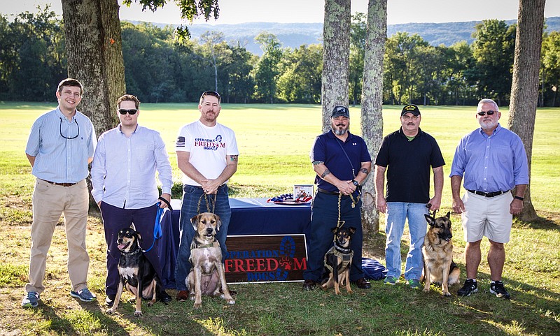 Adam Keith, Dave Childress, Jay Clutter, Jorge Tarafa, Scott Mincey and Pete Moore, from left, pose with service dogs Fox, Colt, Sasha and Sasha during Operation Freedom Dogs' first graduation ceremony in August 2017. Childress of Birchwood, Clutter of Ooltewah, Tarafa of Hixson and Mincey of Ooltewah served as "test dummies" as the program found its footing. (Contributed photo)