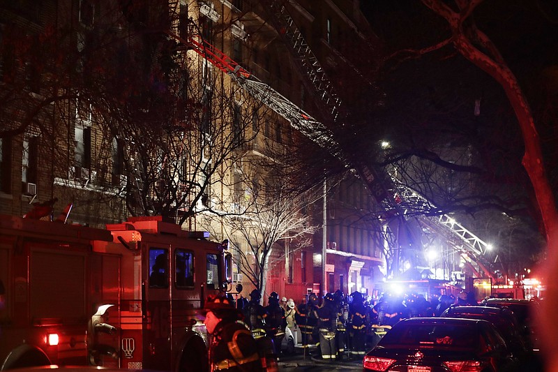 
              Firefighters respond to a building fire Thursday, Dec. 28, 2017, in the Bronx borough of New York. The Fire Department of New York says a blaze raging in the Bronx apartment building has seriously injured more than a dozen of people. (AP Photo/Frank Franklin II)
            