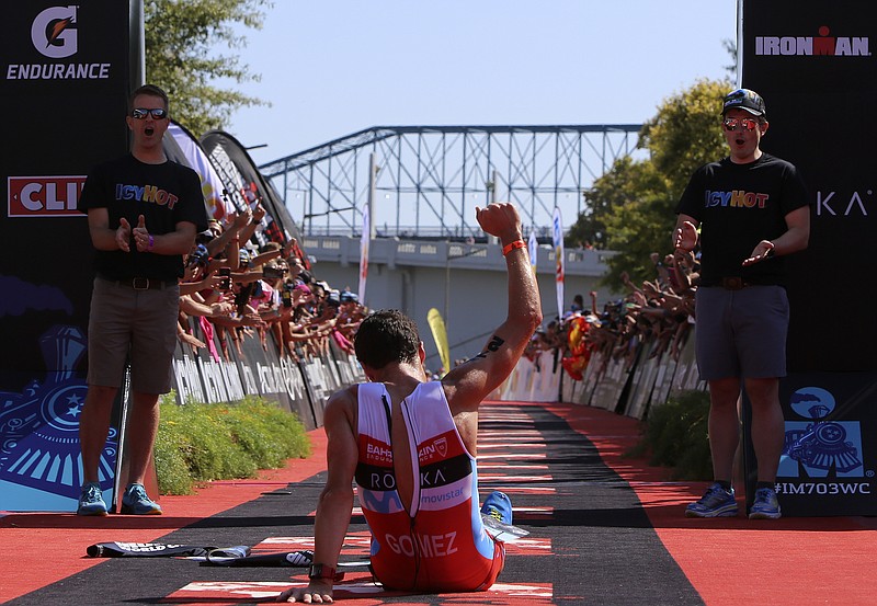 Spain's Javier Gomez gestures after crossing the finish line and winning the Icy Hot Ironman 70.3 World Championship on Sunday, Sept. 10, in Chattanooga, Tenn.