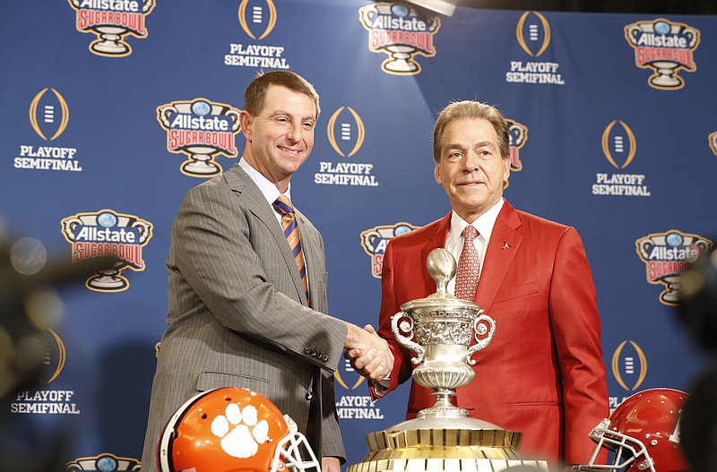 Clemson coach Dabo Swinney and Alabama counterpart Nick Saban pose Sunday with the Sugar Bowl trophy.