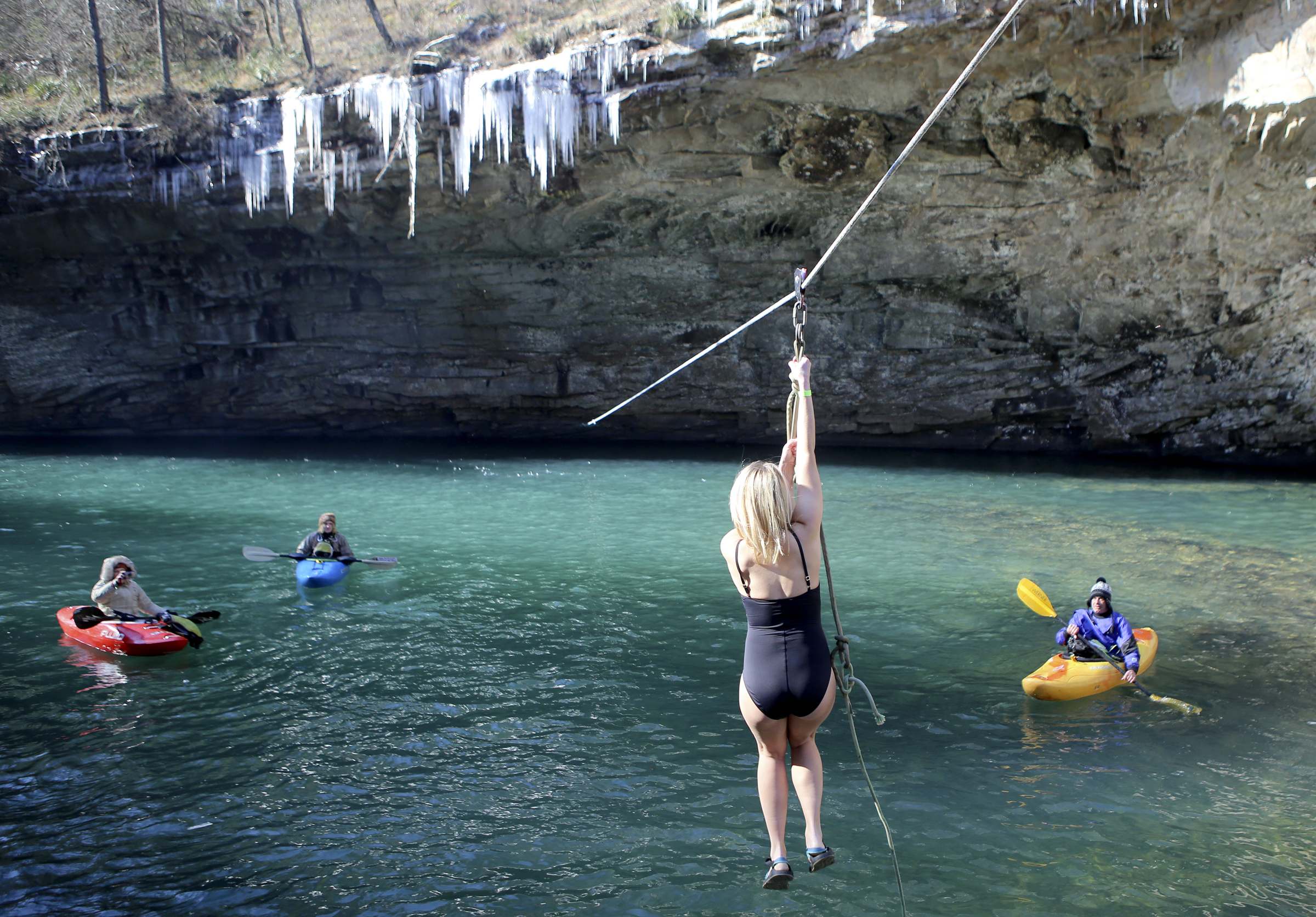 Lexis Robertson zip lines into the water during the second annual Lula Lake Polar Plunge at Lula Lake on Monday, Jan. 1, 2018 in Lookout Mountain, Ga. The entrance fee for the Plunge helped fund the event and the on going conservation efforts by the Lula Lake Land Trust.
