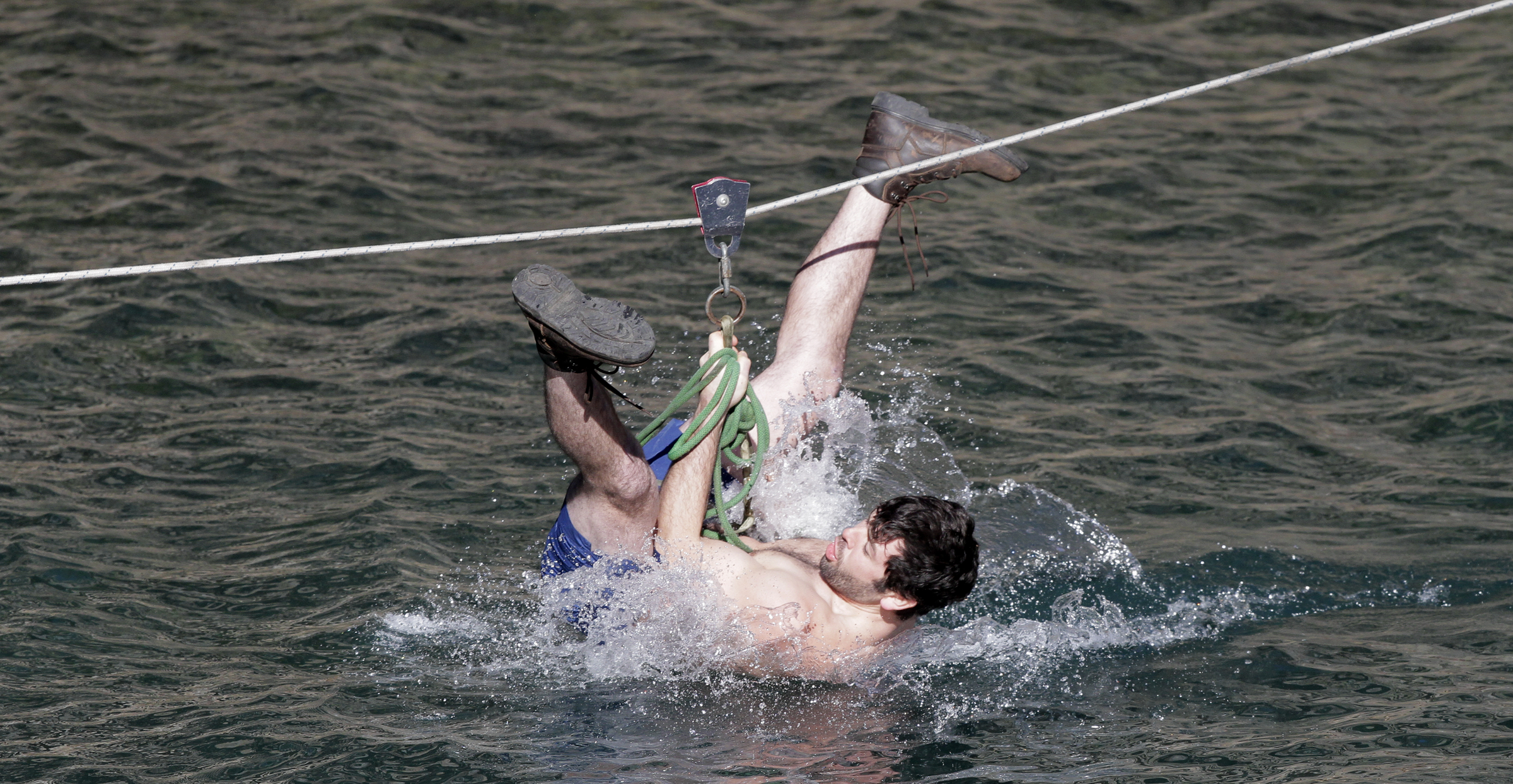 Jonathan Swader reacts as he zip lines into the water during the second annual Lula Lake Polar Plunge at Lula Lake on Monday, Jan. 1, 2018 in Lookout Mountain, Ga. The entrance fee for the Plunge helped fund the event and the on going conservation efforts by the Lula Lake Land Trust.