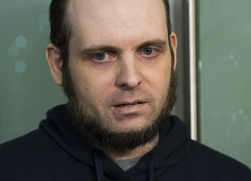 In this Oct. 31, 2017, file photo, Joshua Boyle speaks to the media after arriving at the Pearson International Airport in Toronto. A lawyer for Boyle, a Canadian man recently freed with his American wife and children after years of being held hostage in Afghanistan, says his client has been arrested and faces at least a dozen charges including sexual assault. Attorney Eric Granger said Tuesday, Jan. 2, 2017, that Boyle also faces assault and forcible confinement charges. (Nathan Denette/The Canadian Press via AP)