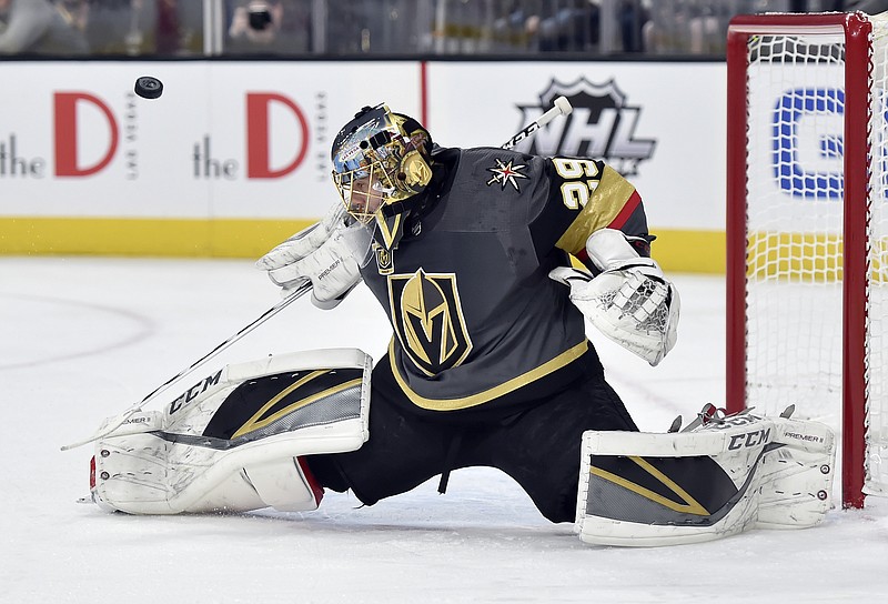Vegas Golden Knights goalie Marc-Andre Fleury deflects the puck on a shot by the Nashville Predators during the first period of an NHL hockey game Tuesday, Jan. 2, 2018, in Las Vegas. (AP Photo/David Becker)