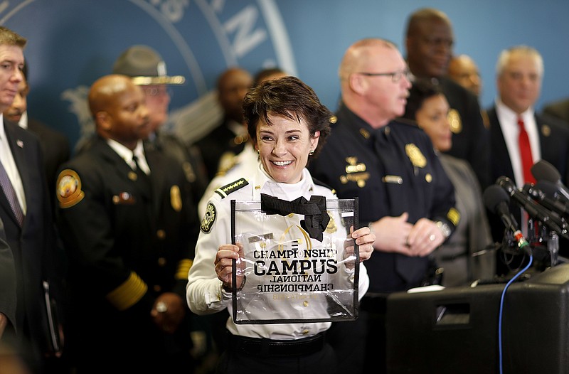 Atlanta Police Chief Erika Shields holds up a clear bag, the only type of bag allowed for fans inside the college football championship game, during a press conference in Atlanta, Thursday, Jan. 4, 2018. Atlanta's mayor is promising a "safe, smooth and secure" college football championship game Monday, despite the traffic problems expected to be caused by President Donald Trump's motorcade, but none of the many agencies involved are taking any chances. (AP Photo/David Goldman)