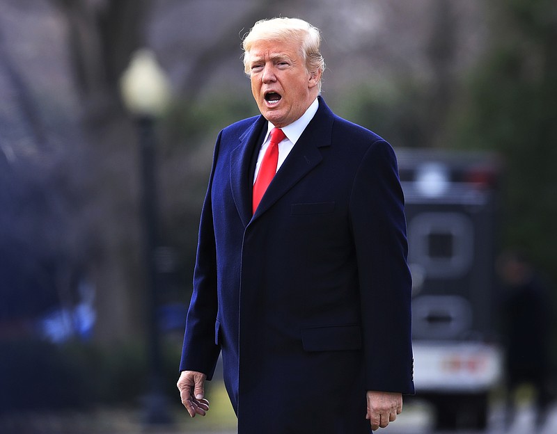 In this Dec. 22, 2017, file photo, President Donald Trump, responds to reporters asking questions as he leaves the White House in Washington. Trump has signed an executive order disbanding his voter fraud commission. The White House in a statement blamed the decision on numerous states that have refused to provide voter information to the Presidential Advisory Commission on Election Integrity. (AP Photo/Manuel Balce Ceneta, File)