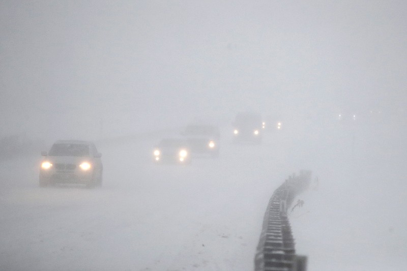 Vehicles commute southbound on the Garden State Parkway in whiteout conditions during a snowstorm, Thursday, Jan. 4, 2018, in Eatontown, N.J. 