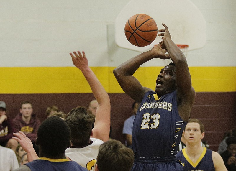 CCS's Mondo Ellison shoots over Grace Academy's Ross Adams during their prep basketball game at Grace Academy on Friday, Jan. 5, 2018, in Chattanooga, Tenn.