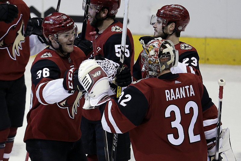 Arizona Coyotes right wing Christian Fischer (36) celebrates with Antti Raanta (32) after scoring in overtime against the Nashville Predators during an NHL hockey game, Thursday, Jan. 4, 2018, in Glendale, Ariz. The Coyotes won 3-2. (AP Photo/Rick Scuteri)