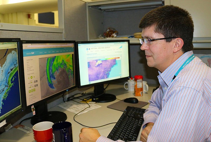Jeff House, a load forecaster for TVA in Chattanooga, reviews  weather forecasts to help TVA predict power demand for its 7-state region.

