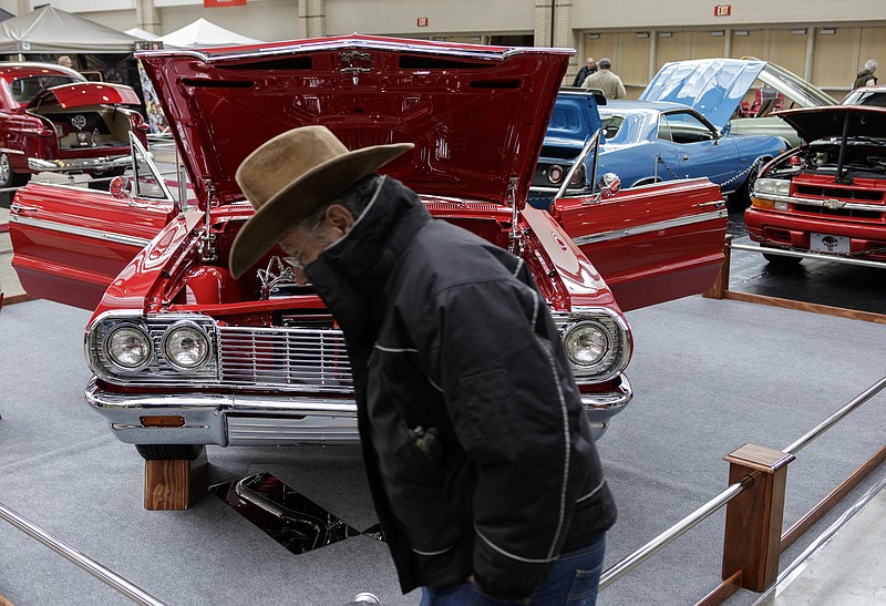 Robert Dollinger walks past a 1964 Chevrolet Impala SS at the 50th Anniversary of the World of Wheels at the Chattanooga Convention Center on Saturday, Jan. 6, 2018, in Chattanooga, Tenn. The event, which showcases classic and modern automobiles, continues Sunday from 11 a.m. to 6 p.m.