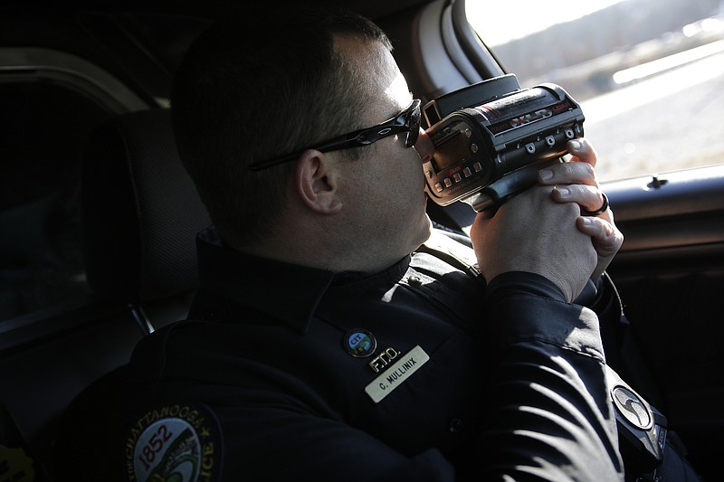 Officer Chris Mullinix uses a laser-assisted radar gun to look for speeding vehicles on Interstate 75 while on traffic patrol on Friday, Jan. 5, 2018, in Chattanooga, Tenn. 