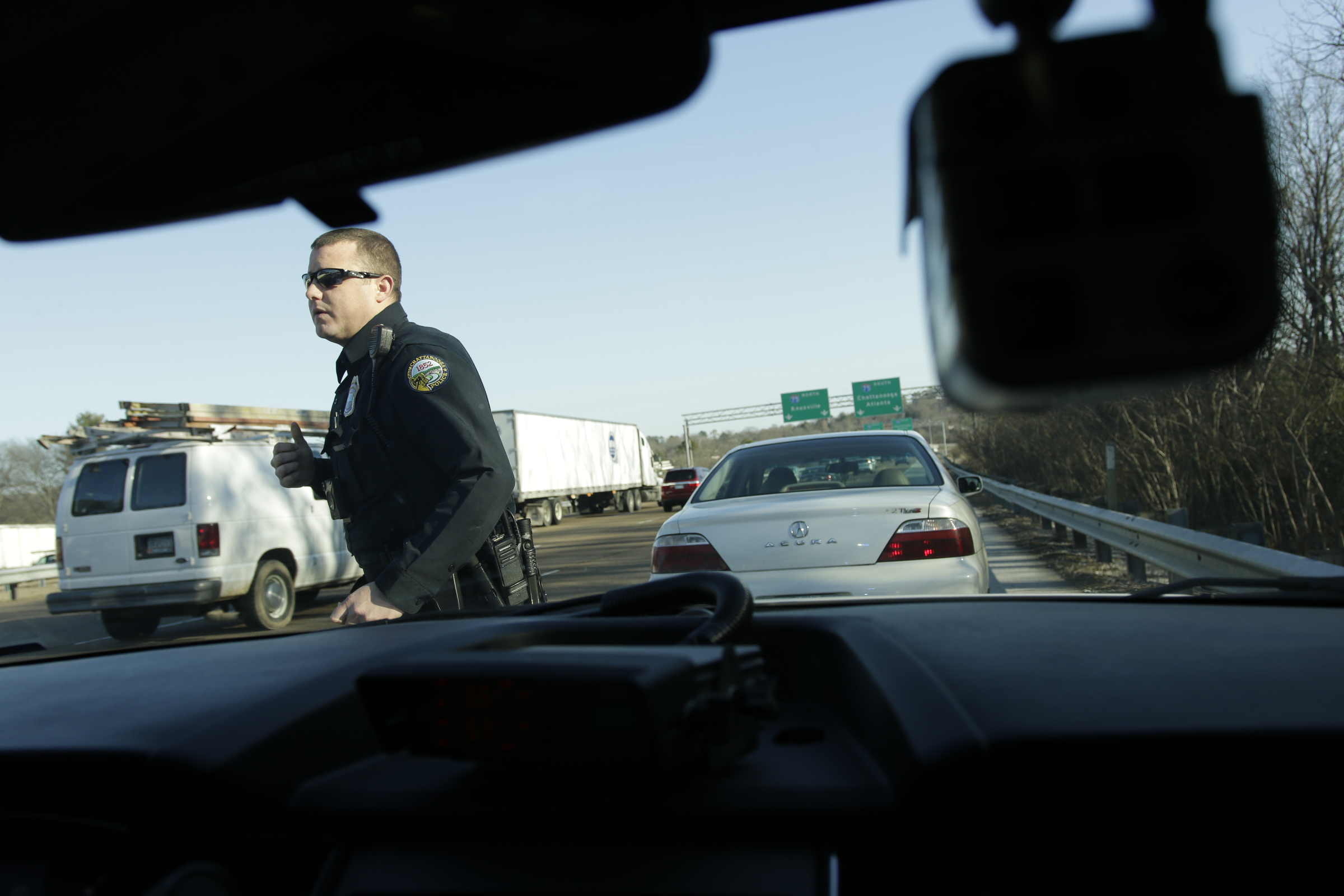 Officer Chris Mullinix returns to his patrol car after issuing traffic citations to a driver on Tennessee Highway 153 while on traffic patrol on Friday, Jan. 5, 2018, in Chattanooga, Tenn.
