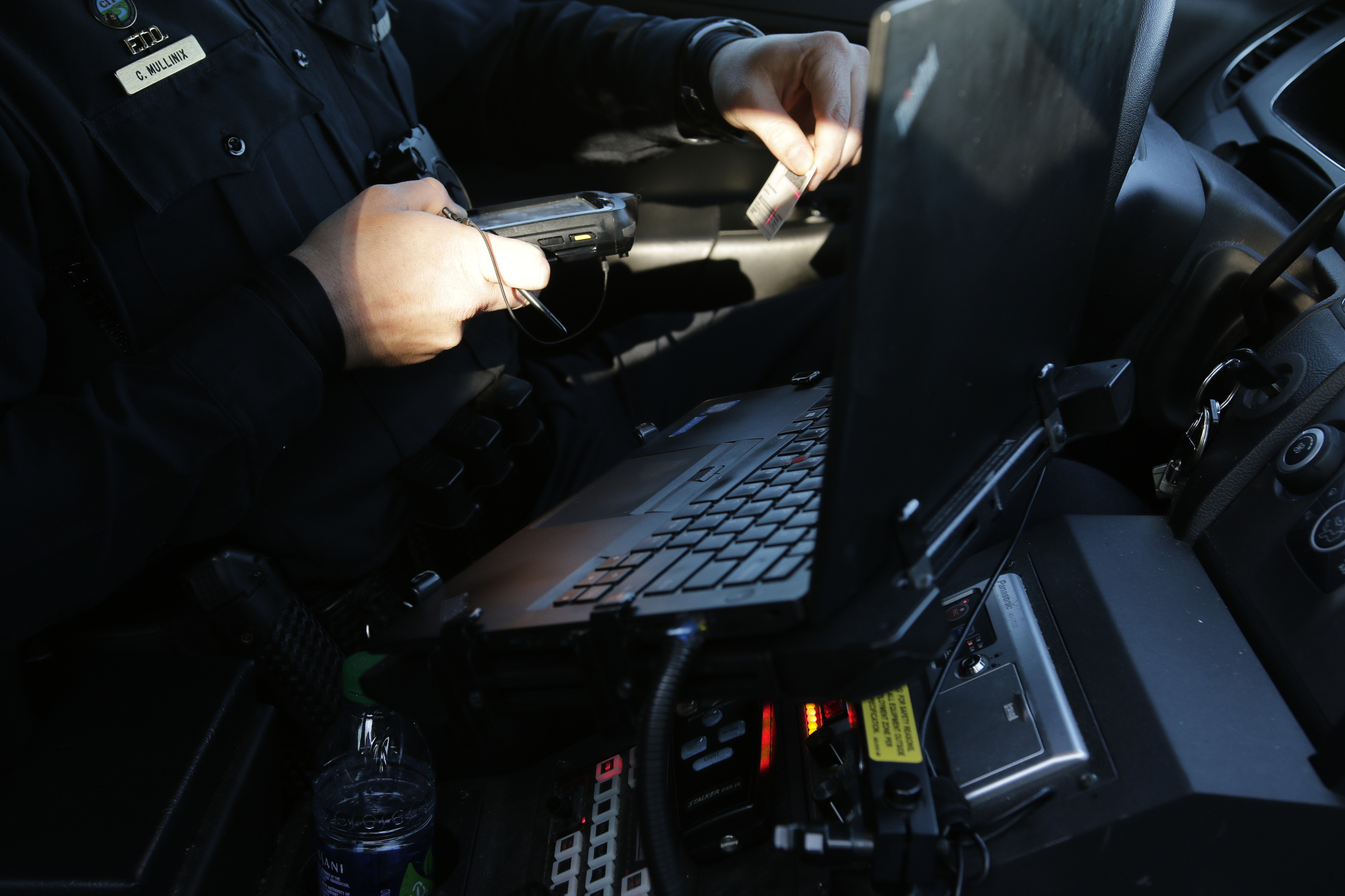 Officer Chris Mullinix uses a handheld device to write a traffic citation while on traffic patrol on Friday, Jan. 5, 2018, in Chattanooga, Tenn.