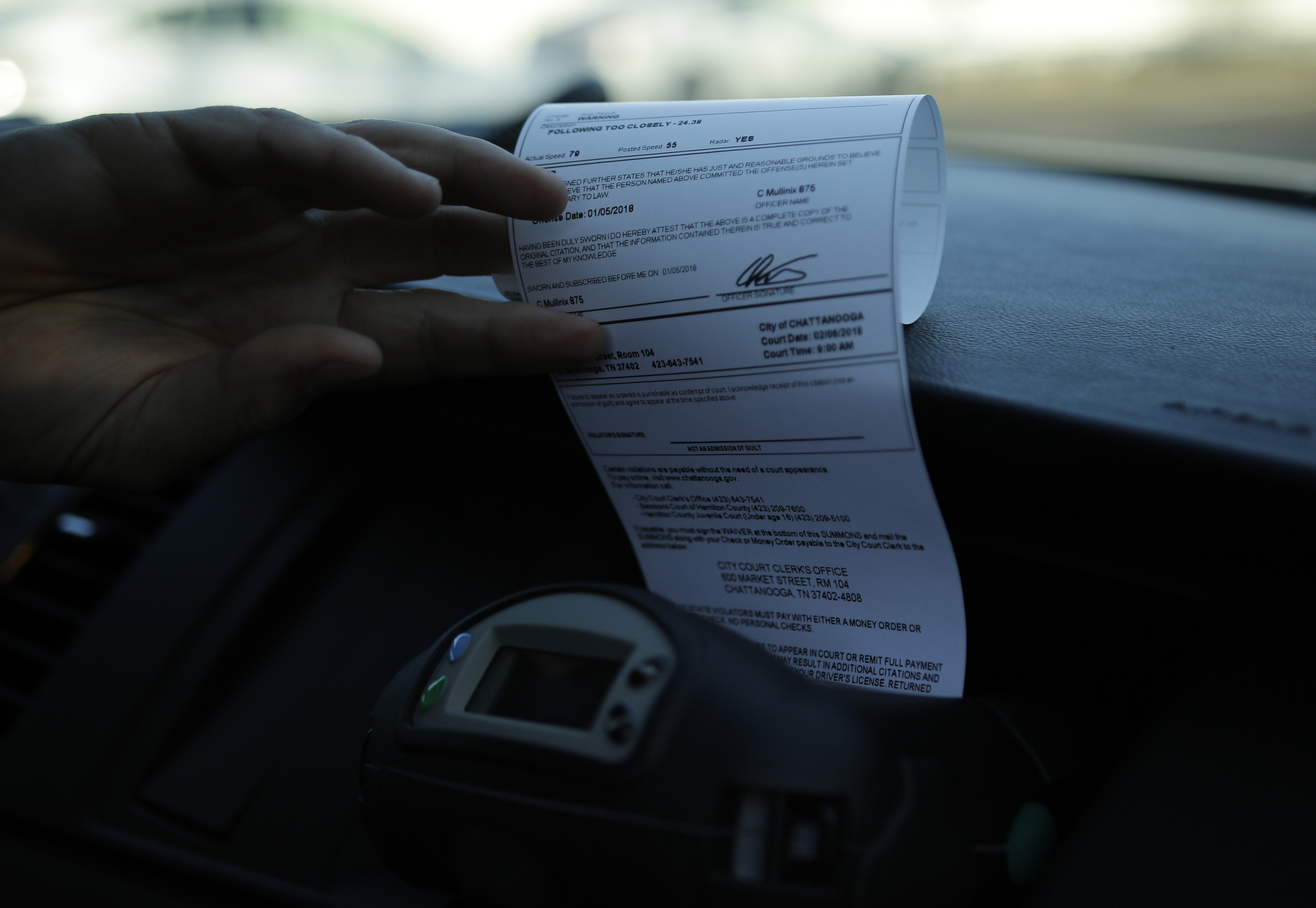 Officer Chris Mullinix prints a traffic citation from a machine in his patrol car while on traffic patrol on Friday, Jan. 5, 2018, in Chattanooga, Tenn.