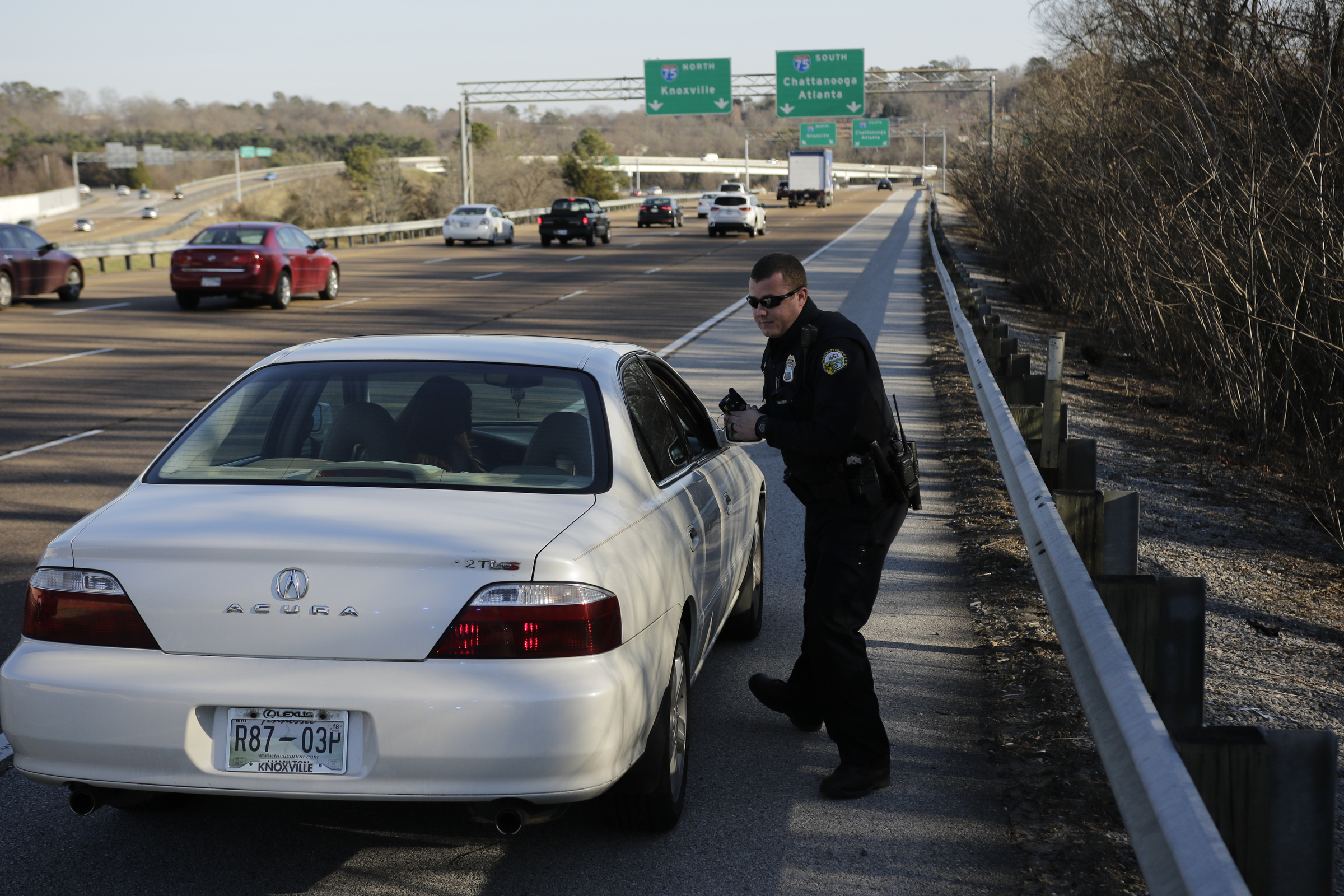 Officer Chris Mullinix issues a driver multiple citations on Tennessee Highway 153 while on traffic patrol on Friday, Jan. 5, 2018, in Chattanooga, Tenn.