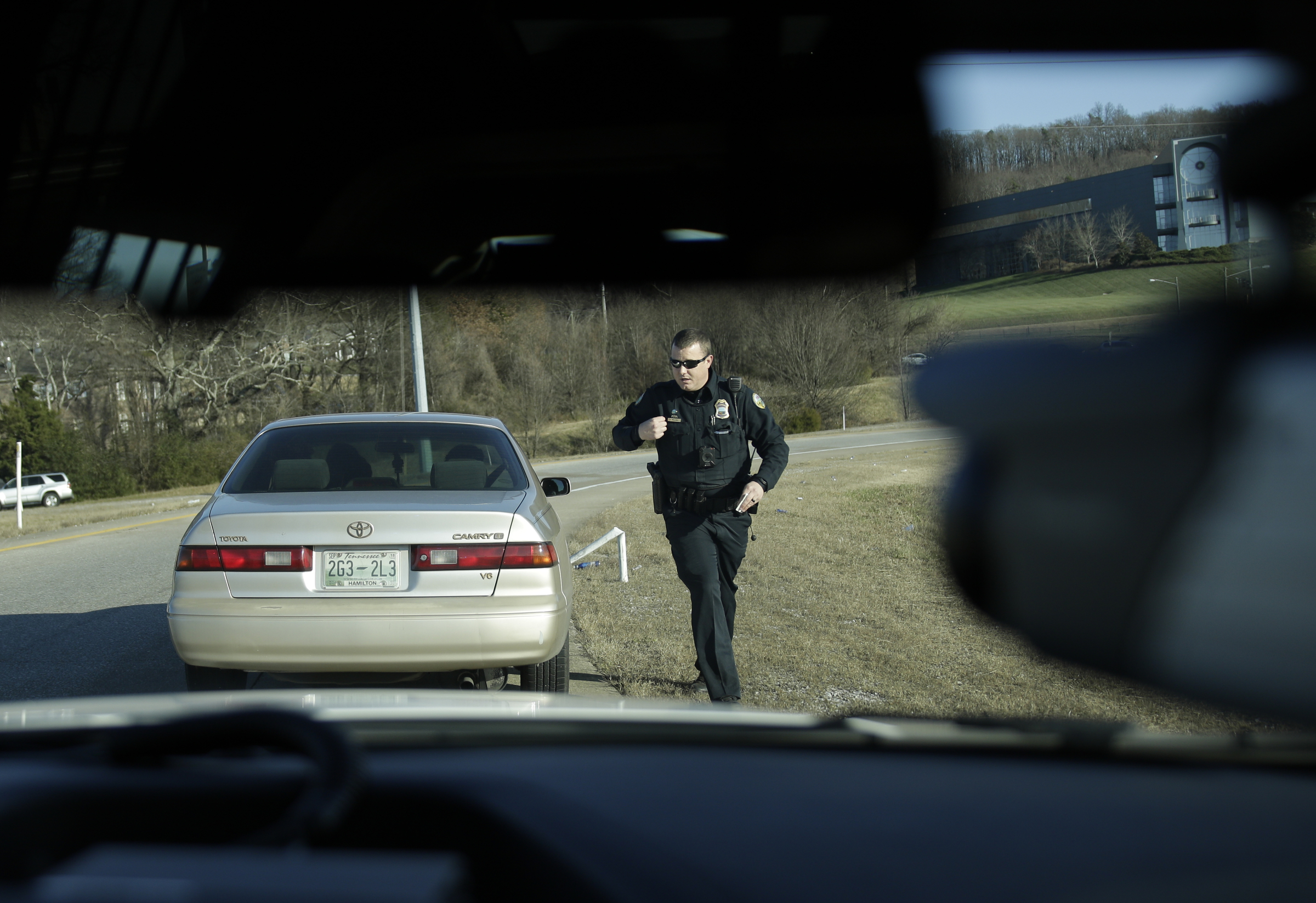 Officer Chris Mullinix returns to his car after issuing a vehicle a speeding citation to an offender while on traffic patrol on Interstate 75 on Friday, Jan. 5, 2018, in Chattanooga, Tenn.
