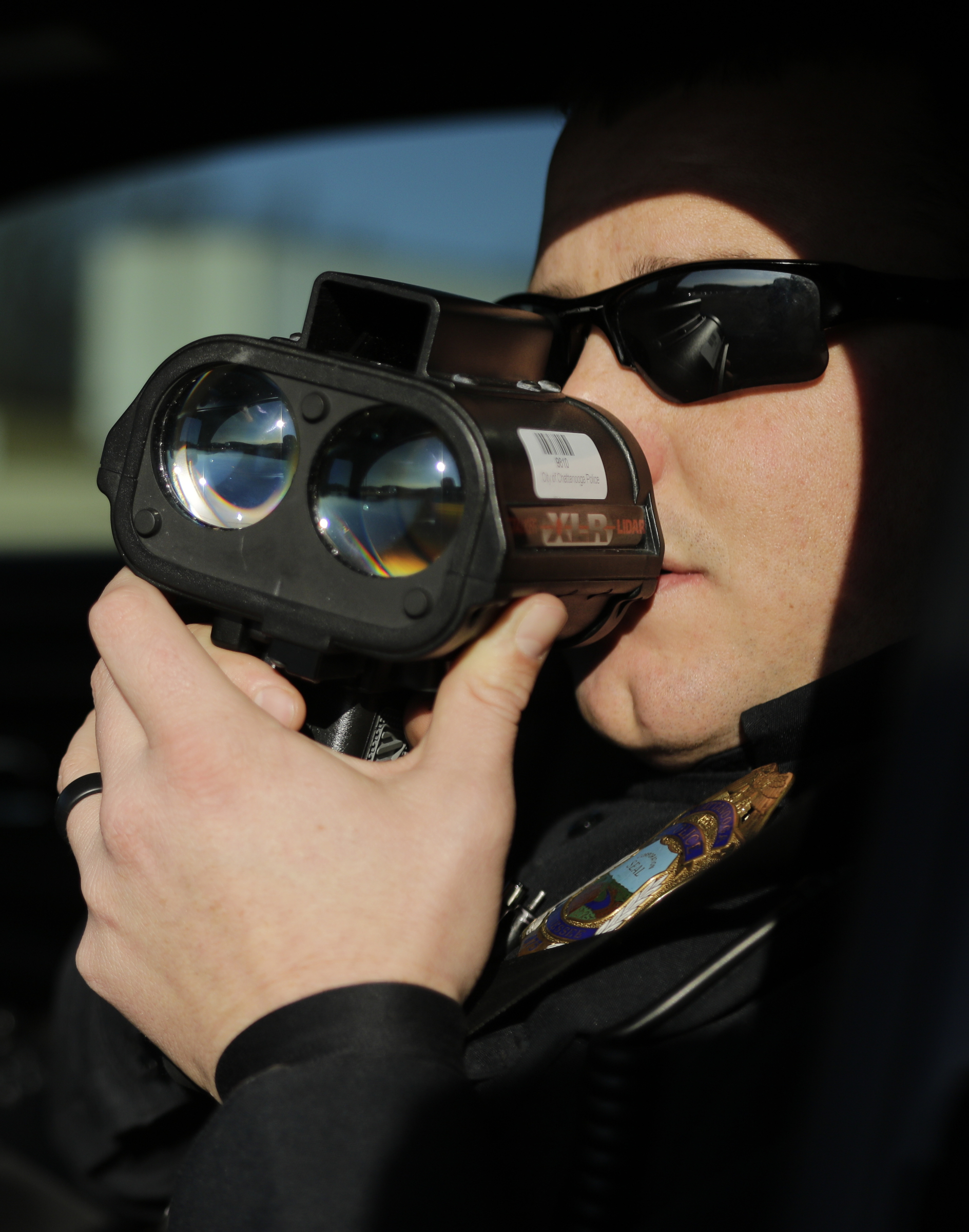 Officer Chris Mullinix uses a laser-assisted radar gun to look for speeding vehicles on Interstate 75 while on traffic patrol on Friday, Jan. 5, 2018, in Chattanooga, Tenn.