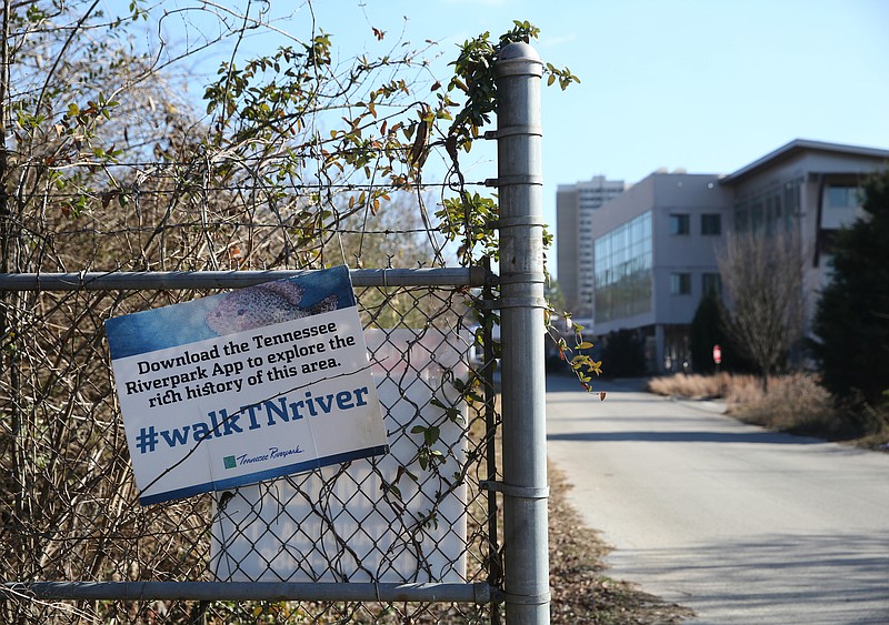 A Tennessee Riverpark sign hangs from the fence alongside West Ninth Street, which currently leads to the Blue Goose Hallow trailhead, Thursday, Jan. 4, 2018 in Chattanooga, Tenn. An expansion is planned for M.L. King Boulevard that will cross Riverfront Parkway to the Blue Goose Hallow trailhead, which will take the place of West Ninth Street. 