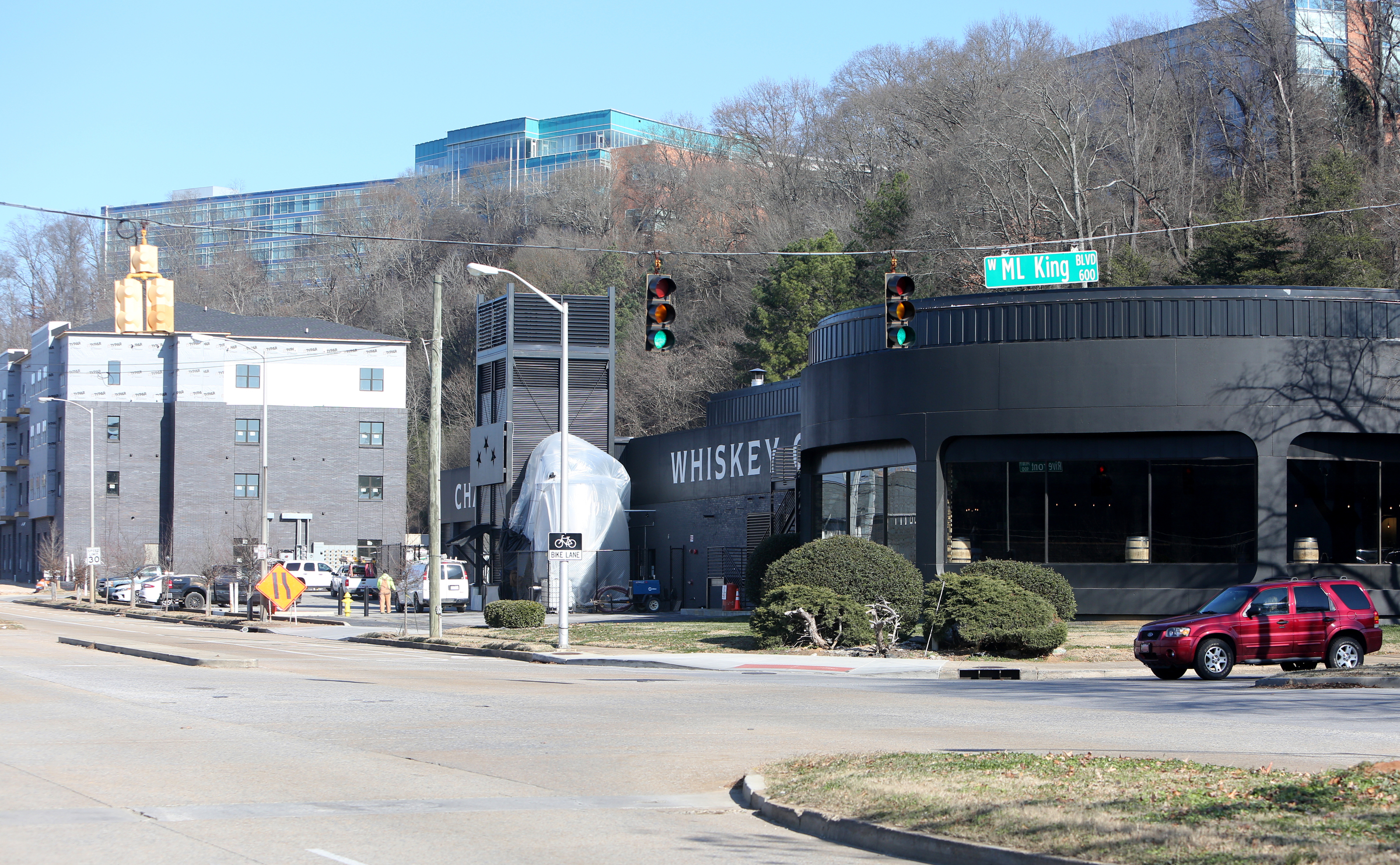 A car sits at the M.L. King Boulevard traffic light at Riverfront Parkway by Chattanooga Whiskey Thursday, Jan. 4, 2018 in Chattanooga, Tenn. There will be a public hearing Monday on the plan to use tax money to expand M.L. King Boulevard straight across Riverfront parkway to the Blue Goose Hallow trailhead.