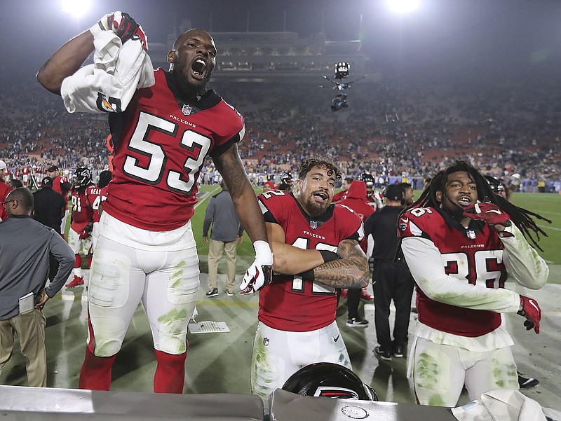 From left, Atlanta Falcons linebackers LaRoy Reynolds and Duke Riley and safety Kemal Ishmael celebrate Saturday night's 26-13 wild-card playoff win against the Rams in Los Angeles. The Falcons play at Philadelphia this Saturday.