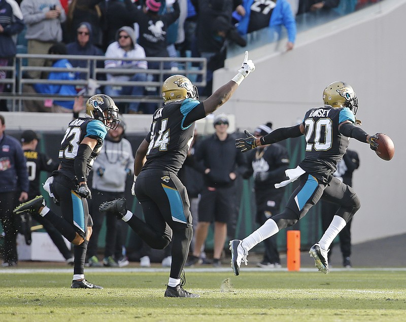 Jacksonville Jaguars cornerback Jalen Ramsey (20) celebrates with a teammate after intercepting a pass against the Buffalo Bills in the final seconds an NFL wild-card playoff football game, Sunday, Jan. 7, 2018, in Jacksonville, Fla. (AP Photo/Stephen B. Morton)