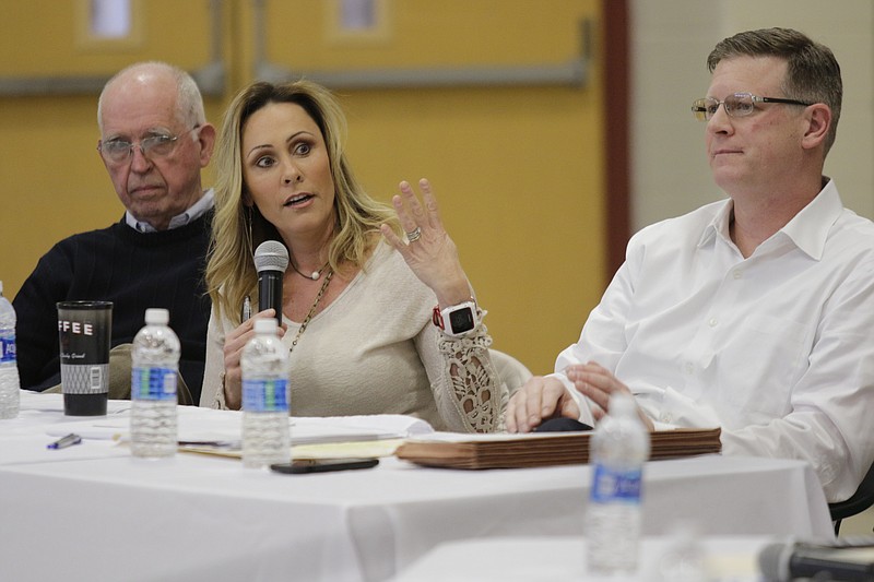 Signal Mountain Vice Mayor Dick Gee, left, and Mayor Chris Howley, right, listen as Councilwoman Amy Speek asks a question during a meeting between the Signal Mountain Town Council and the Hamilton County Board of Education at Nolan Elementary on Thursday, Jan. 4, 2018. Signal Mountain officials and members of the board discussed the town's consideration of splitting from the Hamilton County school system to form their own independent district. (Staff Photo by Doug Strickland)