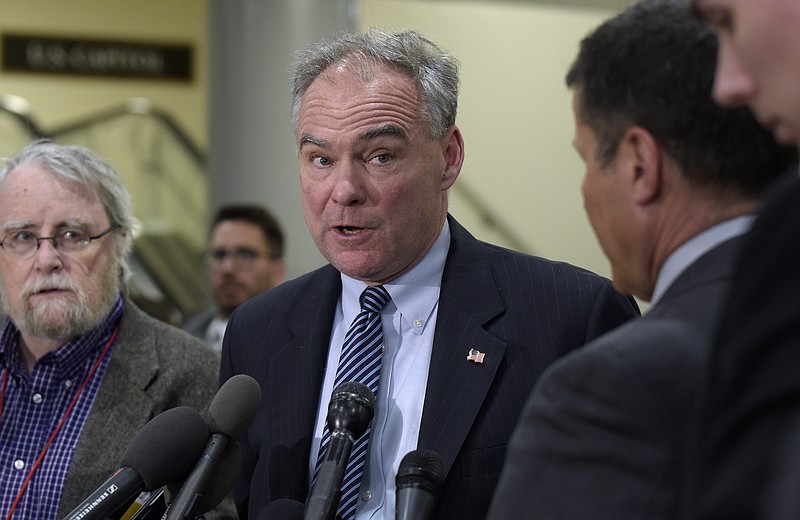 In this April 7, 2017, file photo, Sen. Tim Kaine, D-Va., center, speaks to reporters on Capitol Hill in Washington. Democrats say they're shifting to offense on health care, emboldened by successes in defending the Affordable Care Act. They say their ultimate goal is a government guarantee of affordable coverage for all. (AP Photo/Susan Walsh, File)