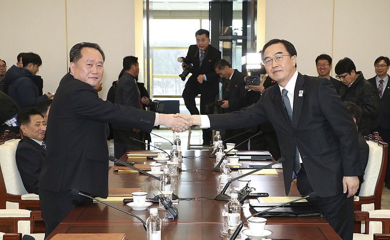 South Korean Unification Minister Cho Myoung-gyon, right, shakes hands with the head of North Korean delegation Ri Son Gwon before their meeting at the Panmunjom in the Demilitarized Zone in Paju, South Korea, Tuesday, Jan. 9, 2018. South Korean media said North and South Korea have begun talks at their border about how to cooperate in next month's Winter Olympics and how to improve their long-strained ties. (Korea Pool/Yonhap via AP)