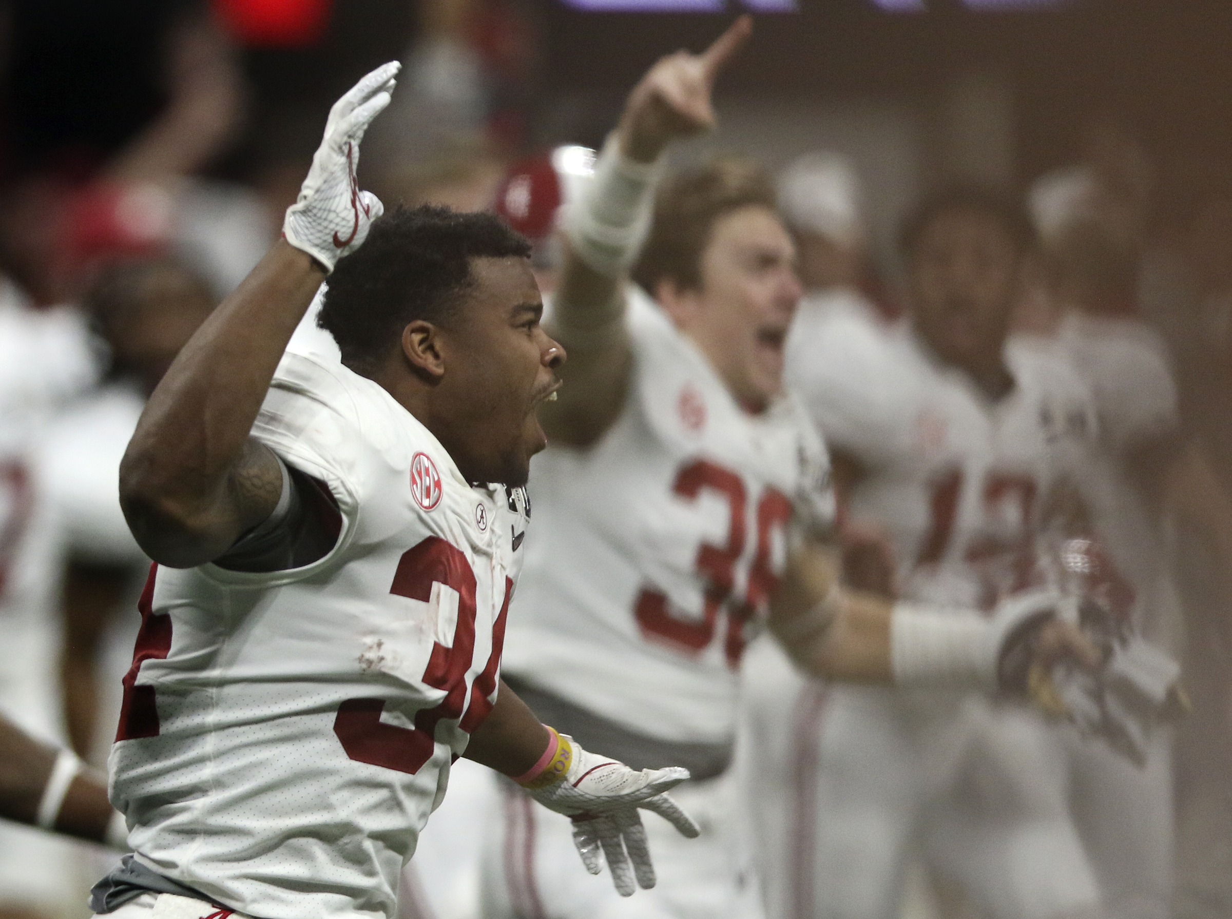 Alabama running back Damien Harris (34) celebrates as Alabama defeated Georgia in overtime to win the College Football Playoff national championship at Mercedes-Benz Stadium on Tuesday, Jan. 9, 2018 in Atlanta, Ga.